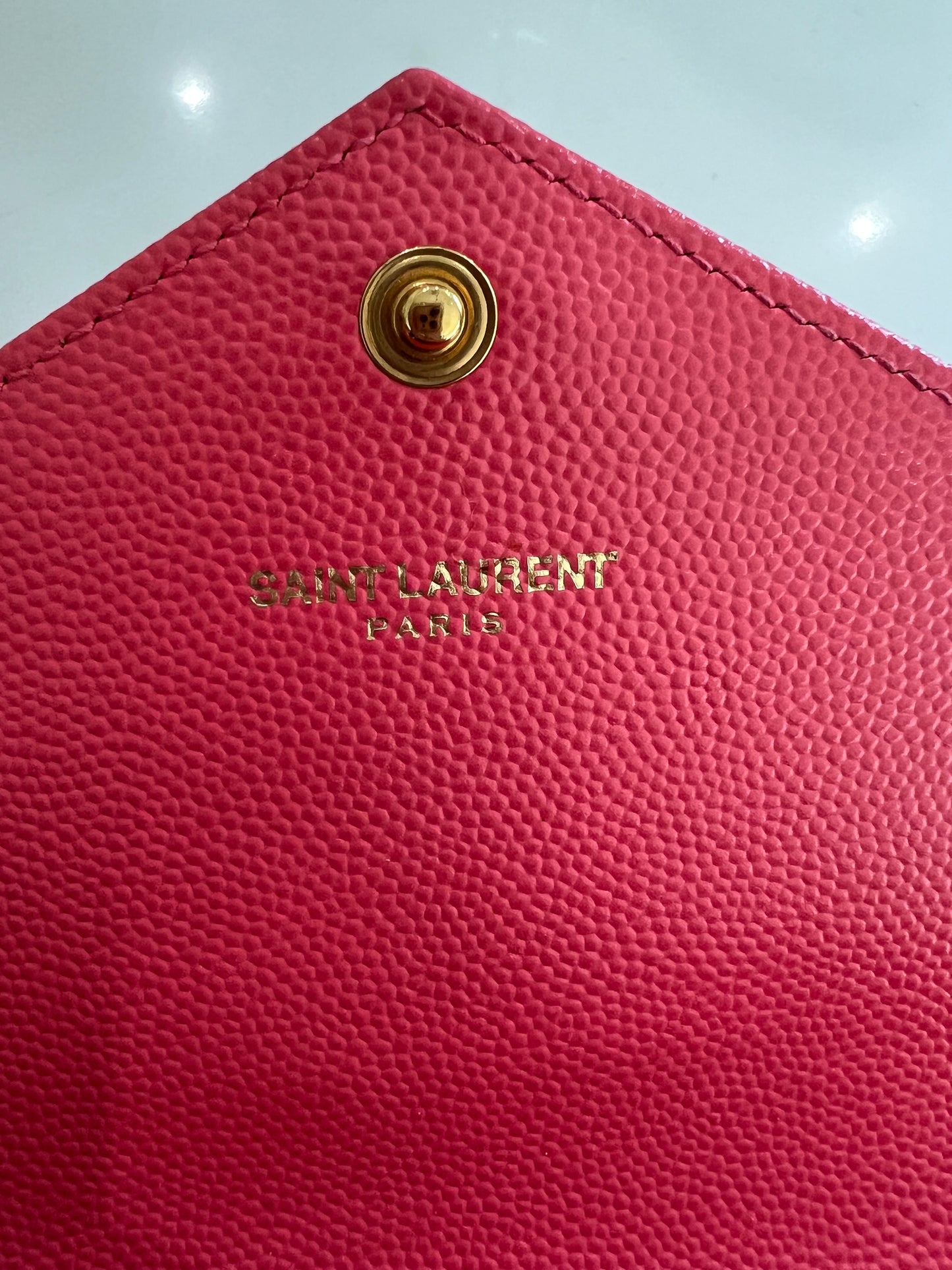 Pink YSL cassandre envelope wallet on chain